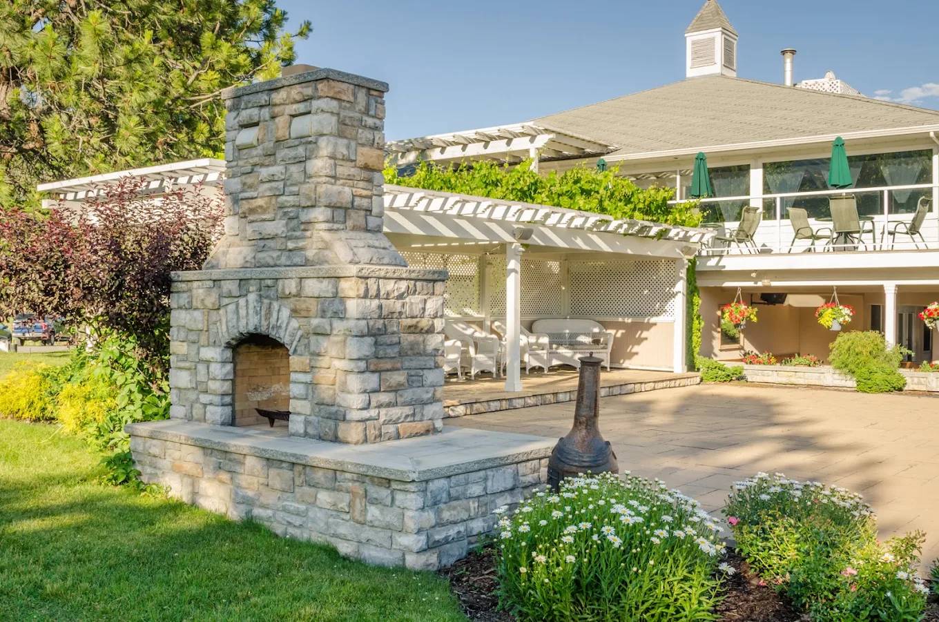 Outdoor stone fireplace and patio at golden hour